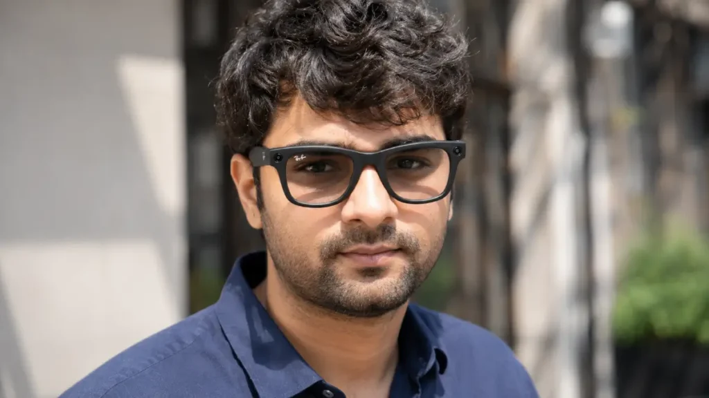Close up of a young man wearing Meta Ray-Ban Gen 2 smart glasses showing the classic frame and hidden camera lens.