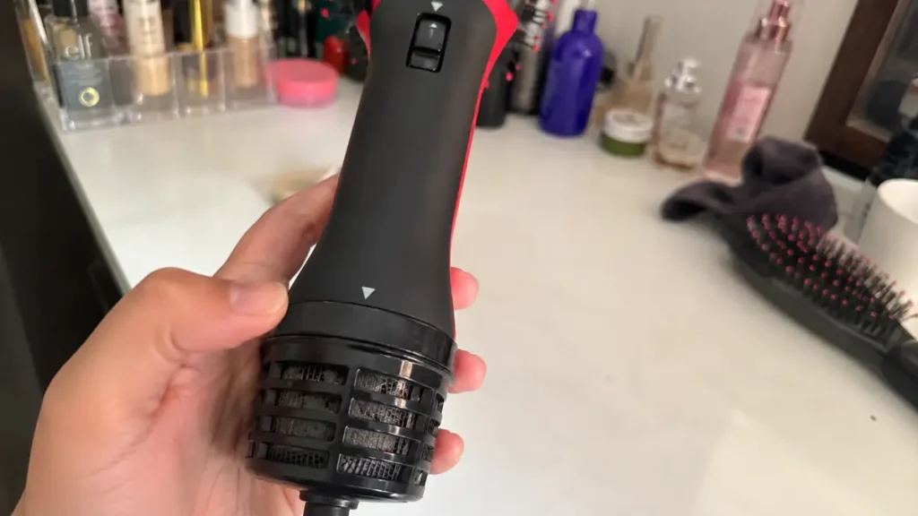 Close up shot of the twist control dial at the bottom of a hair styling tool handle.